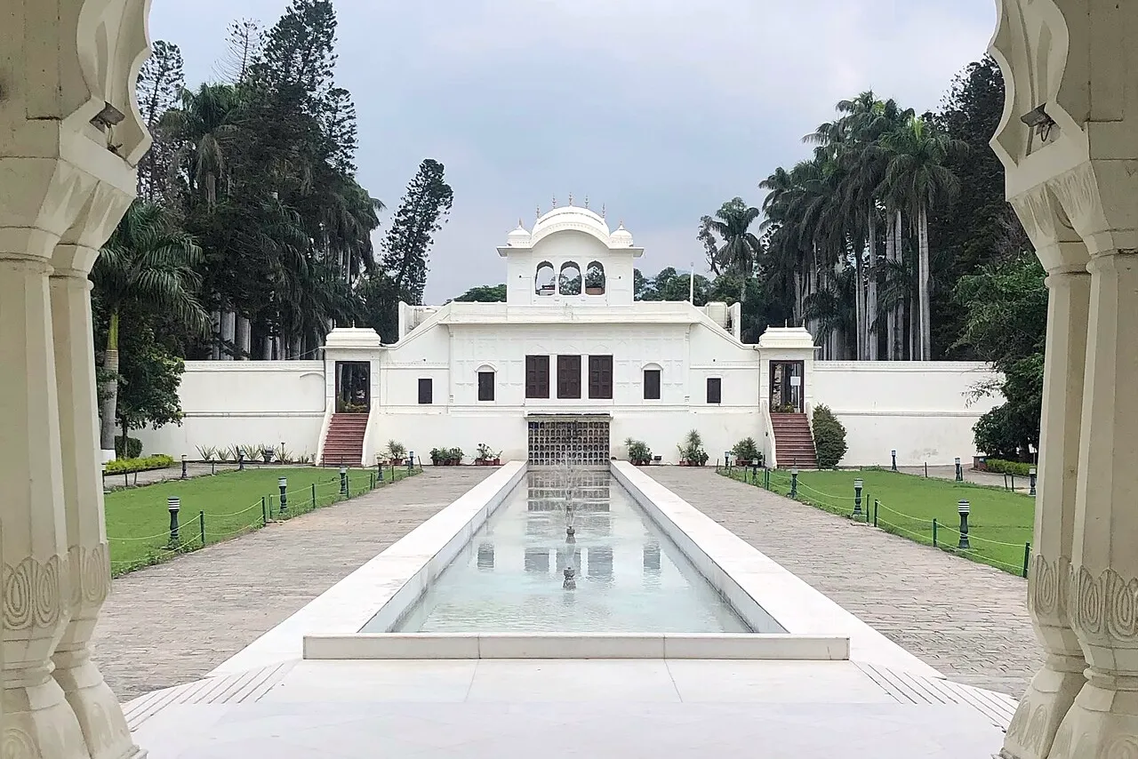 Formal landscaped garden with clipped hedges and a central lawn at a Ludhiana residence