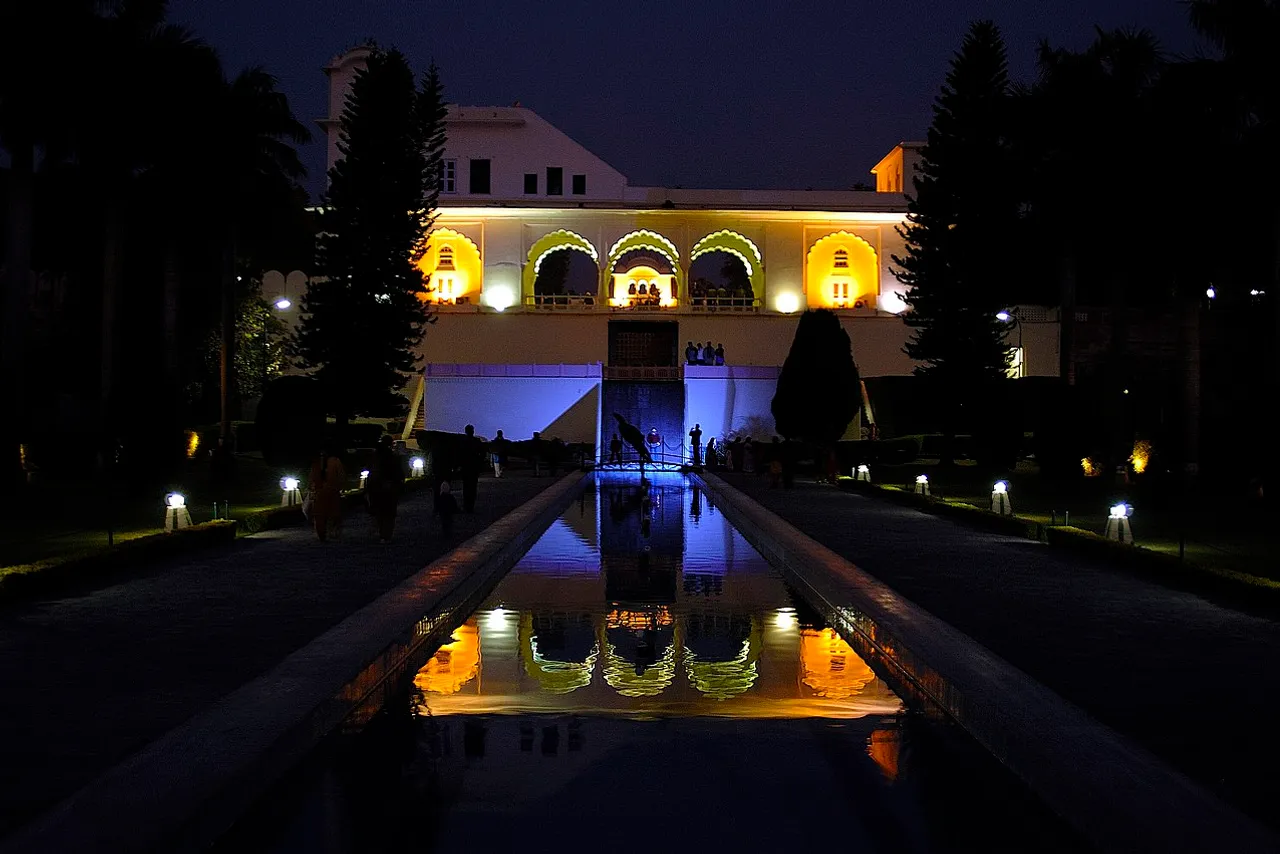 Garden path lit warmly at dusk with low-level landscape lighting